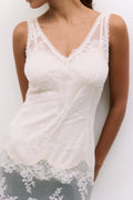 White lace tank top worn by a person on a white background