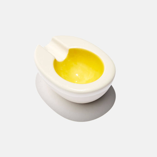 Hard-boiled egg with a knife on a white background