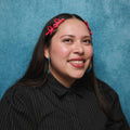 Woman with pink hair clips against a blue background