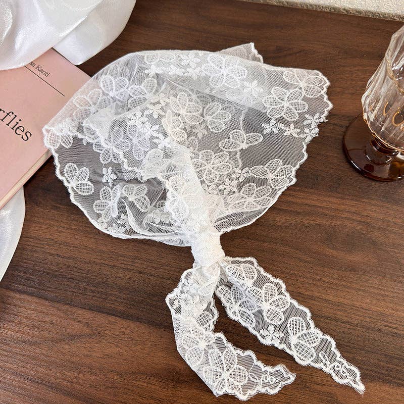 White lace headband on a wooden surface