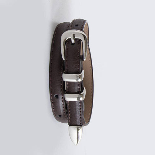 Brown leather belt with silver buckle and spike on a light gray background