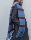 Person wearing a blue and red striped scarf with a plain background