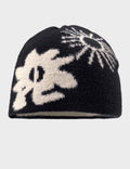 Black beanie with white floral pattern on a light gray background