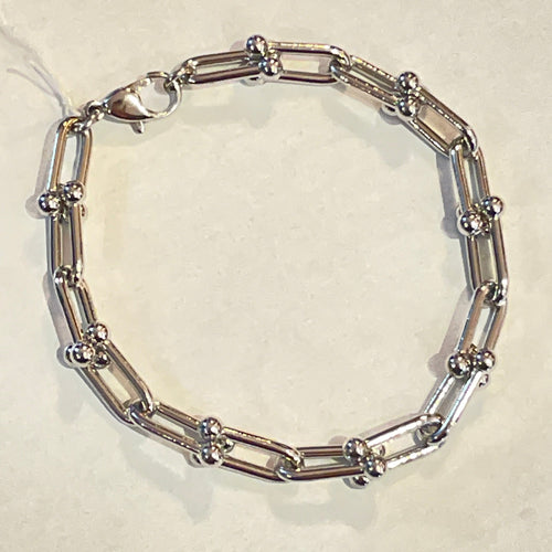 Silver bracelet on a light beige background