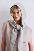 Woman wearing a gray hooded scarf against a white background