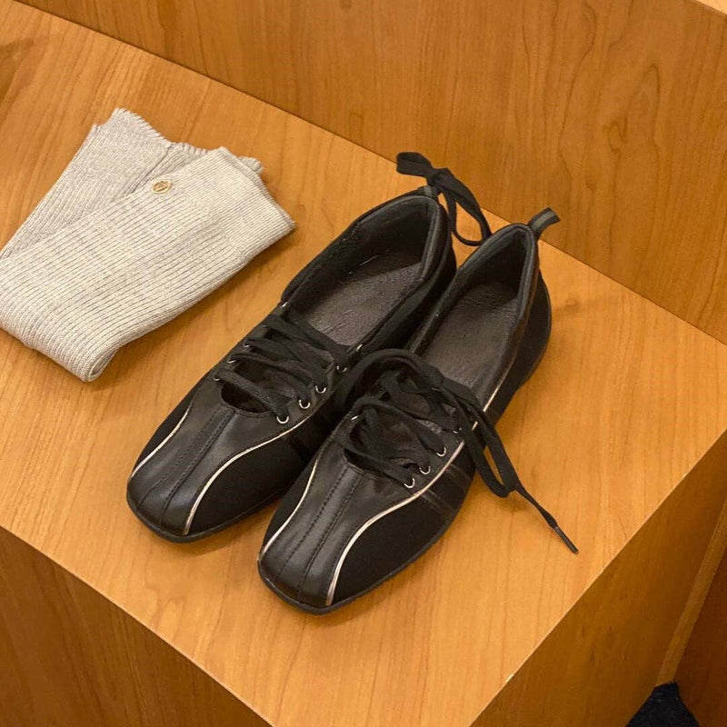 black shoes with white trim on wooden bench