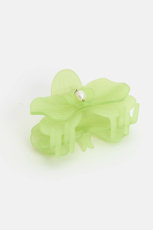 Light green hair clip on a white background