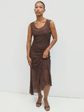 Woman wearing a brown lace dress against a white background