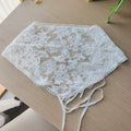White lace fabric on a wooden surface