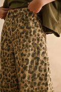 Leopard print pants worn by a person with a neutral background