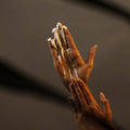 Close-up of a hand with a textured surface against a dark background