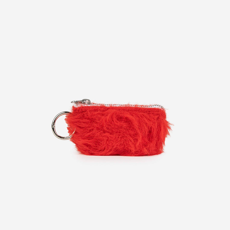 Red furry pouch with a metal ring on a white background