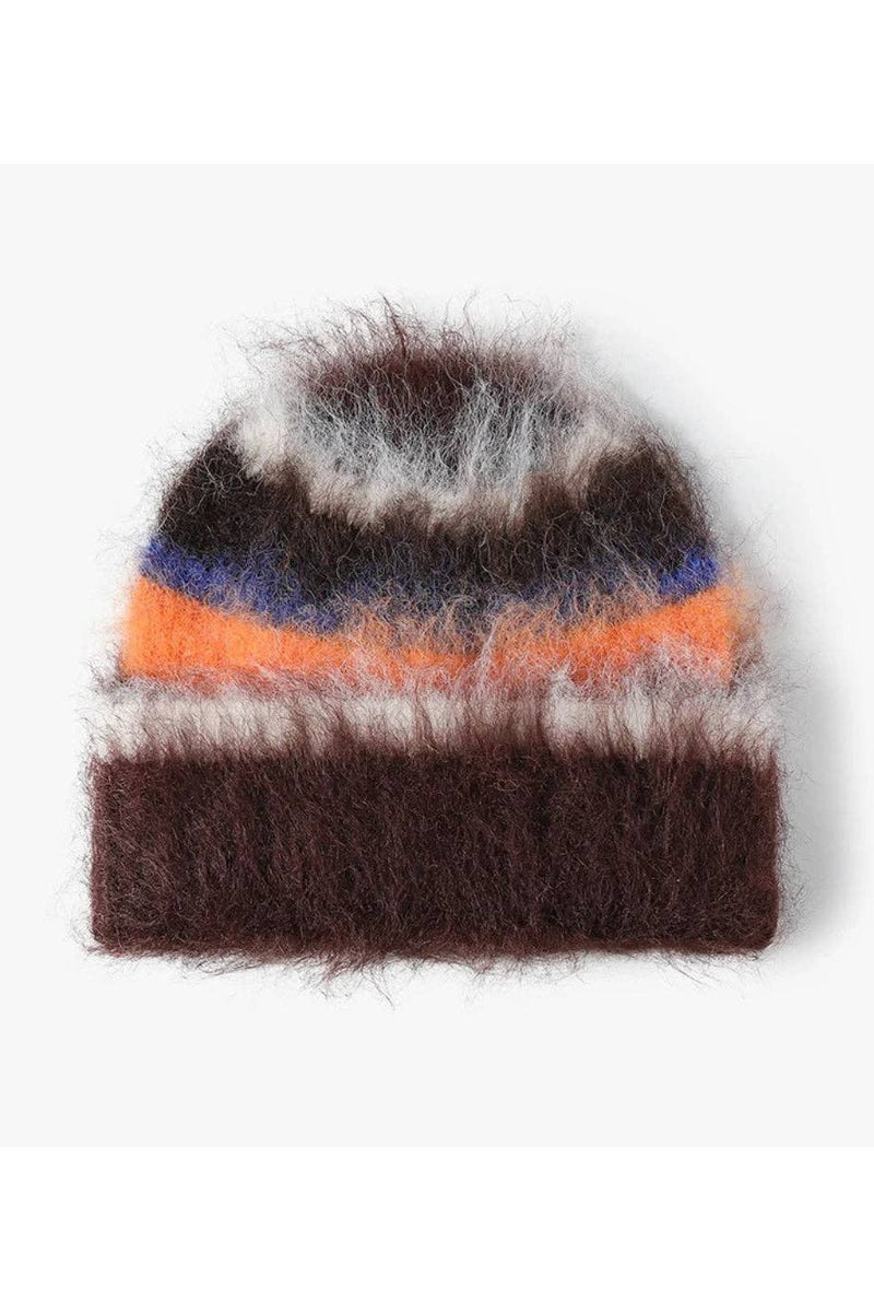 A fuzzy knit beanie hat with horizontal stripes in dark brown, orange, blue, white, and black, featuring a fluffy pom-pom on top, shown against a plain light gray background.
