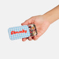 Hand holding a small tin labeled 'Chunks' with gummy candy on a white background
