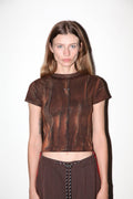 Model wearing a brown textured top and pants on a white background
