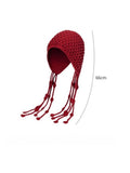 Red knitted hat with long strings on a white background