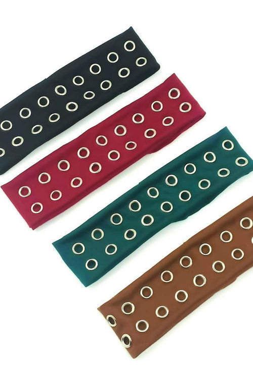 Four headbands in black, red, green, and brown with circular cutouts on a white background.
