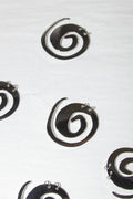 Black spiral earrings on a white background
