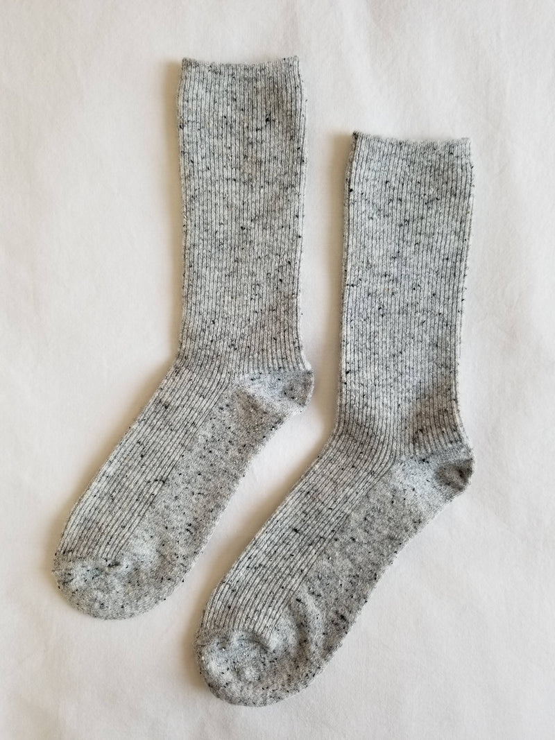 Pair of gray socks on a light beige background