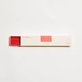 Box of incense sticks with red interior on a white background