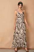 model wearing brown and white zebra dress on tan background