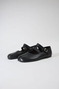 Pair of black Mary Jane shoes on a white background