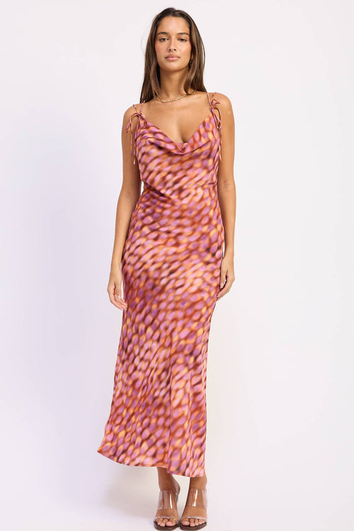 Woman wearing a patterned dress on a white background