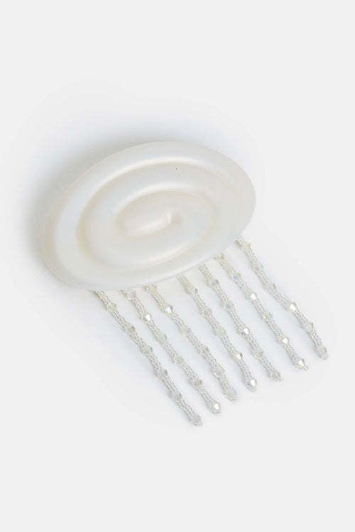 White hair comb on a light gray background