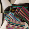 Stack of colorful striped socks on a white surface