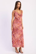 Woman wearing a patterned dress on a white background