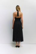 Back view of black and white polka dot dress.