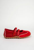 A red flat shoe with a perforated upper, double hook-and-loop strap closure, and a tan outsole, shown from the side on a light gray background.