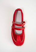 A red Mary Jane style shoe with two straps and a pointed toe, photographed from above on a plain white background.