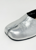 Silver tabi shoe on a white background