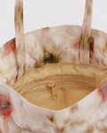 Floral-patterned tote bag with a zipper on a white background