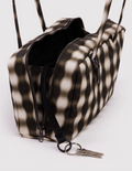 Patterned handbag with a keychain on a white background