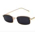Gold-framed sunglasses with black lenses on a white background