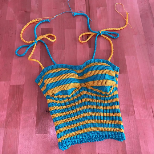 Blue and yellow striped crop top on a wooden floor