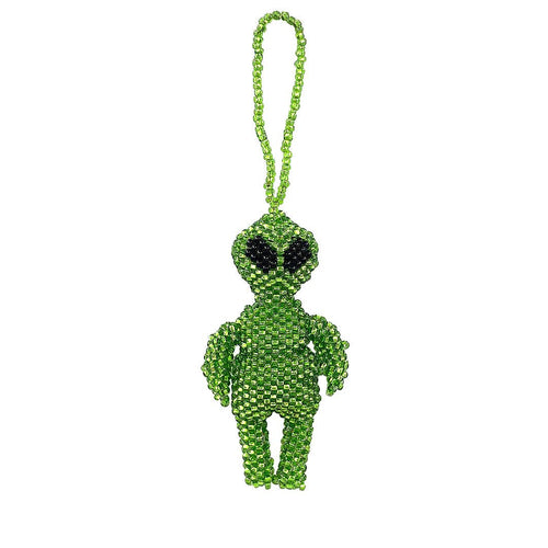 Green beaded alien charm with a string on a white background