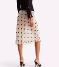Polka dot skirt worn by a person on a white background