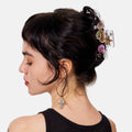Woman with decorative hair accessories and a black tank top on a white background