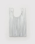 Silver fringe bag on a light gray background