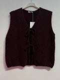 Brown knitted vest on a hanger with a tag against a white background