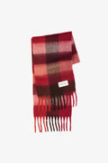 Red and brown plaid scarf with a brand label on a white background