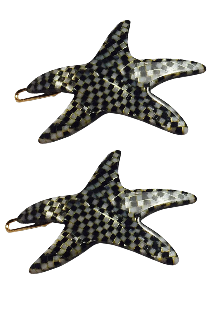 Two starfish-shaped hair claw clips with a black and white checkered pattern and gold-tone metal clasps, shown on a plain white background.
