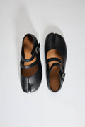 Pair of black shoes with a strap on a white background