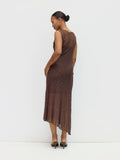 Woman wearing a brown lace dress against a white background