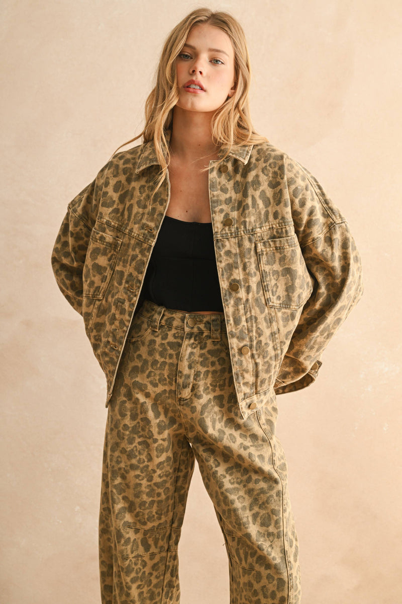 Woman wearing a leopard print jacket and pants on a beige background