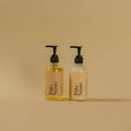 Two bottles of Palo Santo on a beige background