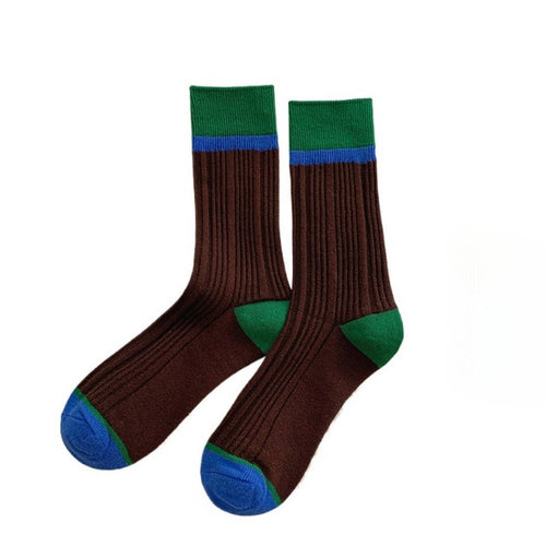 Pair of brown socks with green and blue accents on a white background